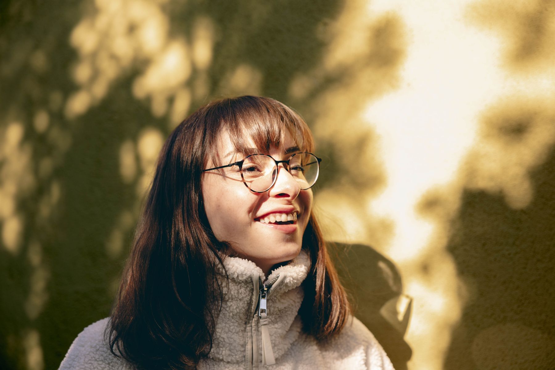 A woman smiling in the sunshine